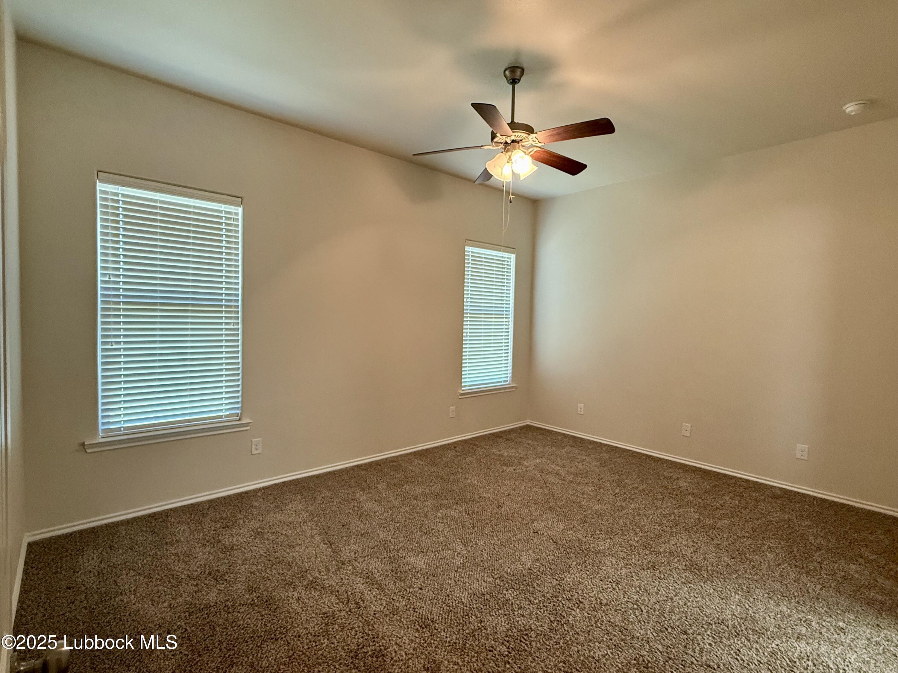 7046 95th Street Lubbock, TX 79424 - Photo 12 of 23 a view of an empty room with a window