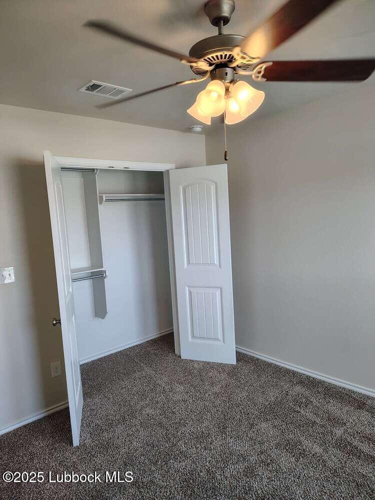 7046 95th Street Lubbock, TX 79424 - Photo 17 of 23 a view of a livingroom with a chandelier fan