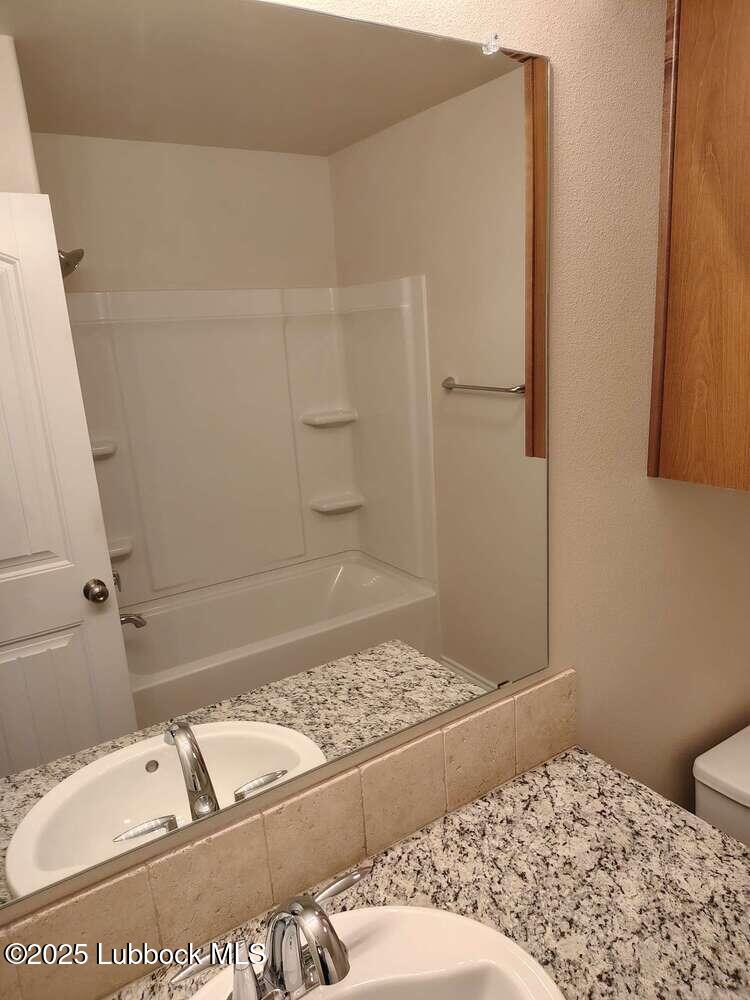7046 95th Street Lubbock, TX 79424 - Photo 19 of 23 a bathroom with a bathtub and shower