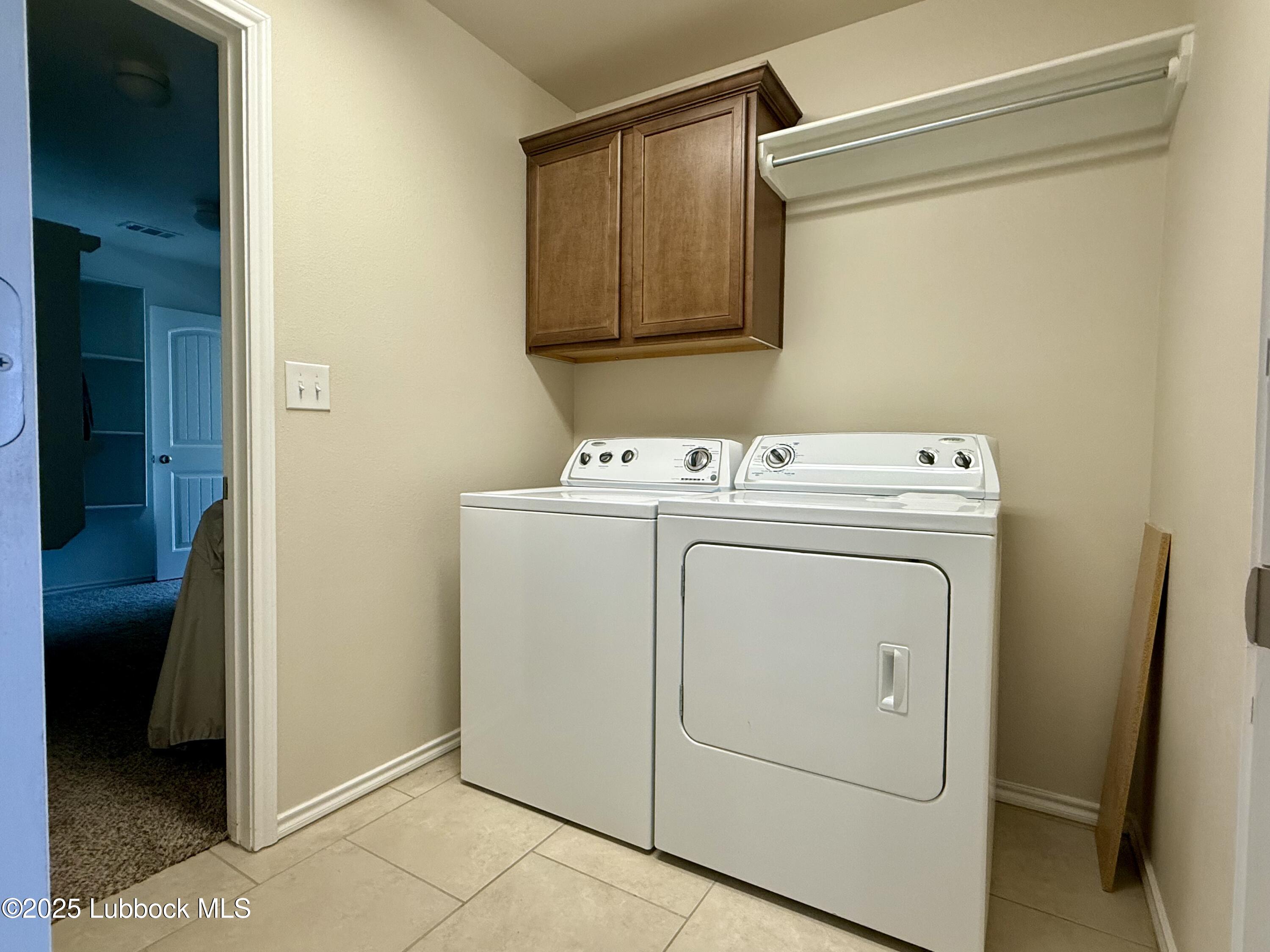 7046 95th Street Lubbock, TX 79424 - Photo 22 of 23 a utility room with dryer and washer