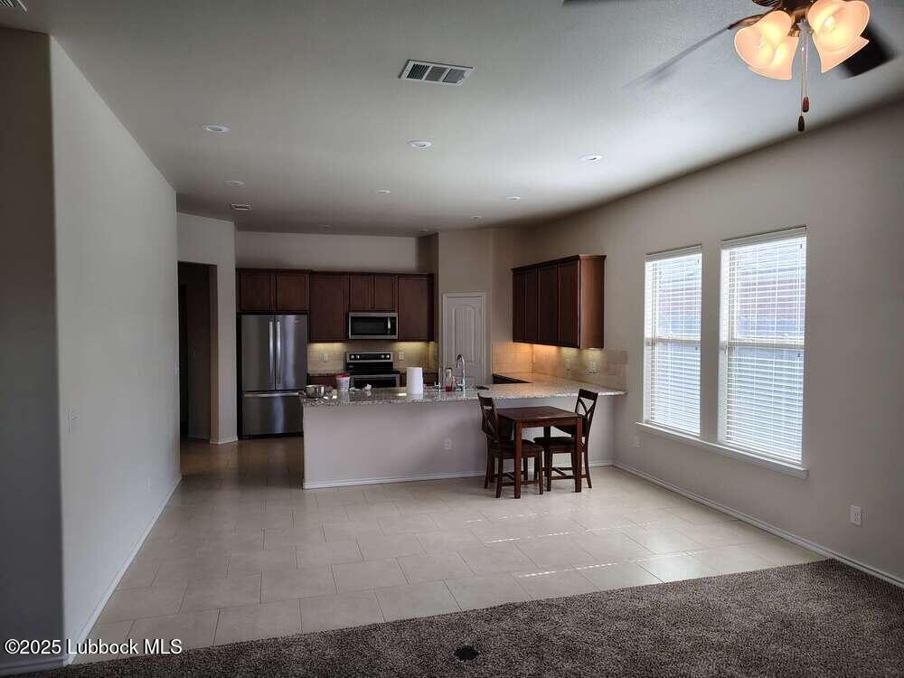 7046 95th Street Lubbock, TX 79424 - Photo 9 of 23 a view of a livingroom with furniture and a window