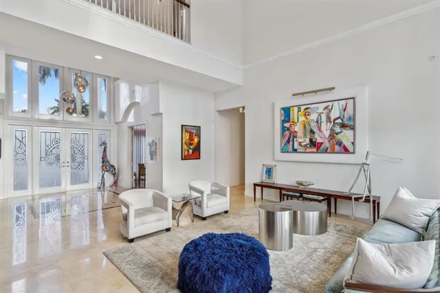 a living room with a bed and wooden floor