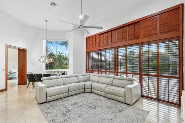 a view of a house with a yard and palm trees