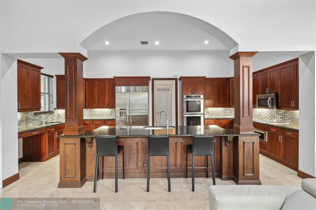 2753 West Stonebrook Circle Davie, FL 33330 - Photo 18 of 88 a kitchen with stainless steel appliances kitchen island granite countertop a stove and cabinets