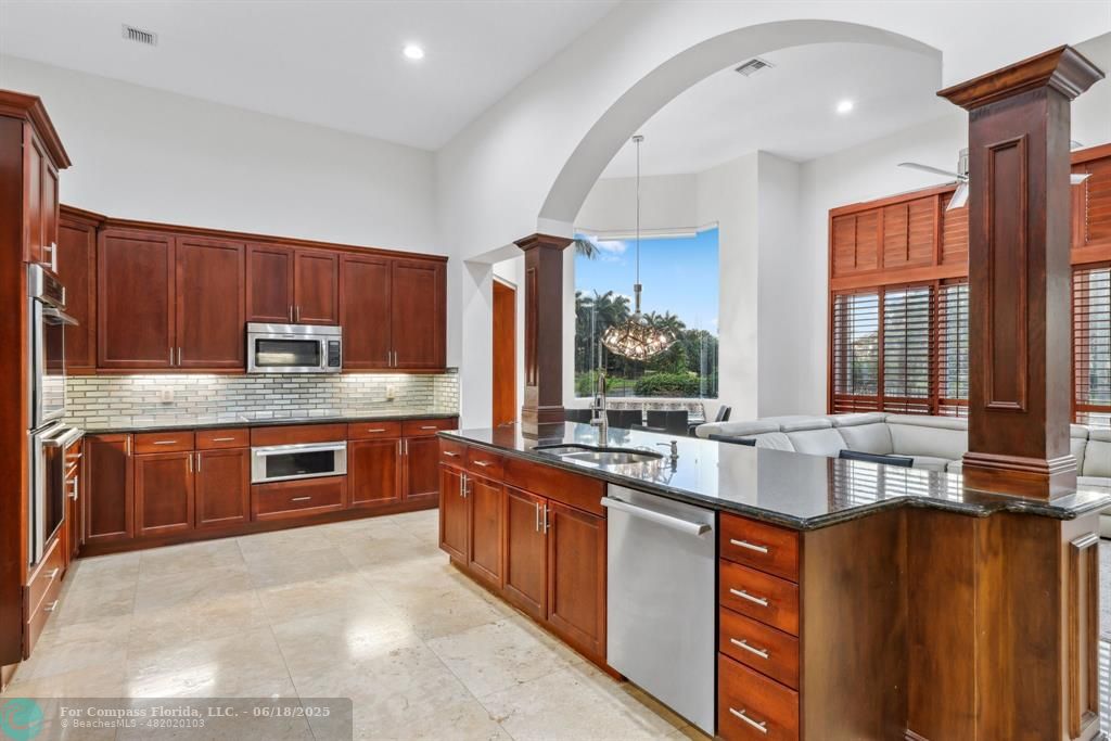 2753 West Stonebrook Circle Davie, FL 33330 - Photo 21 of 88 a large kitchen with stainless steel appliances granite countertop a stove a sink dishwasher and microwave
