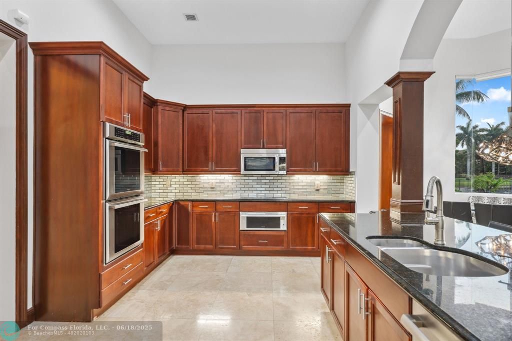 2753 West Stonebrook Circle Davie, FL 33330 - Photo 23 of 88 a kitchen with stainless steel appliances granite countertop a sink stove and refrigerator