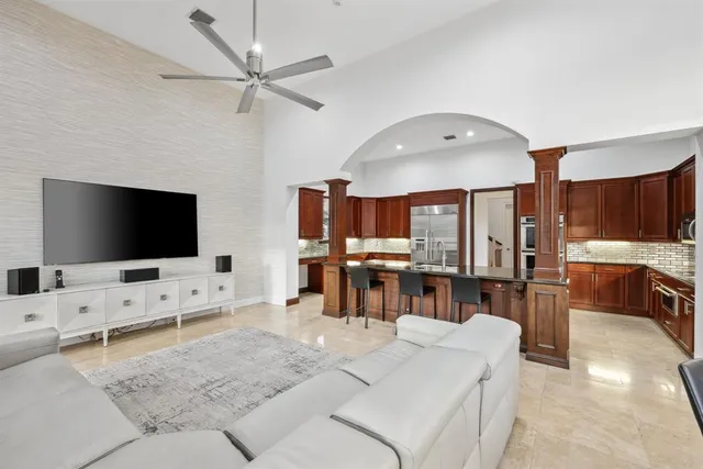 a view of a swimming pool with a yard and palm trees