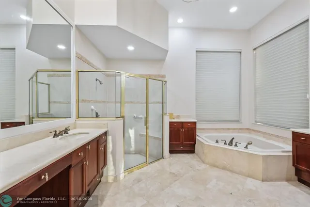 a bathroom with a granite countertop toilet sink and mirror
