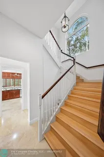 a sidewalk with a palm trees