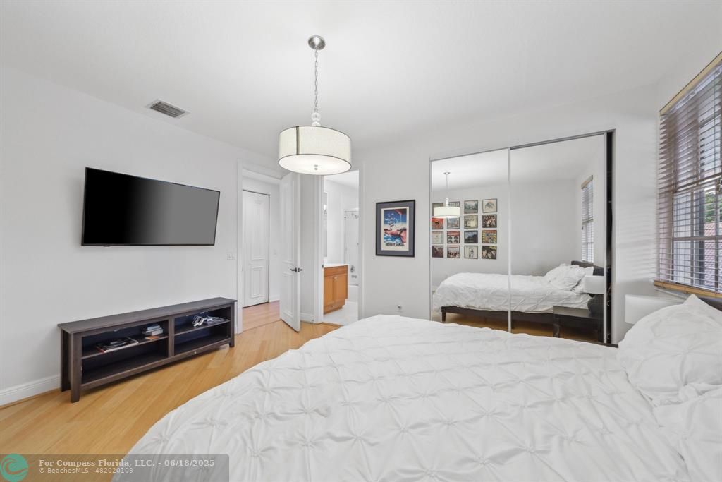 2753 West Stonebrook Circle Davie, FL 33330 - Photo 39 of 88 a bedroom with a bed and a flat screen tv