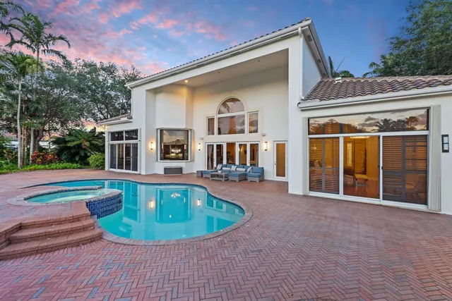 a living room with furniture a rug and a painting on the wall