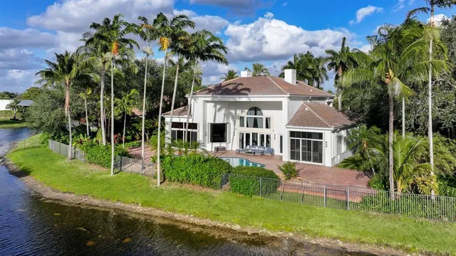 a view of a dining room with furniture and a chandelier