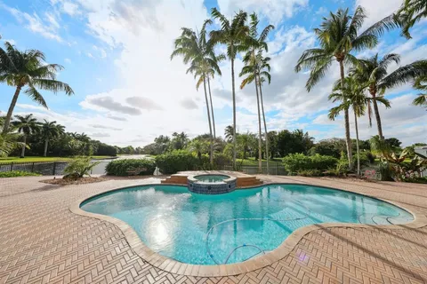 a dining hall with stainless steel appliances granite countertop a stove and a sink