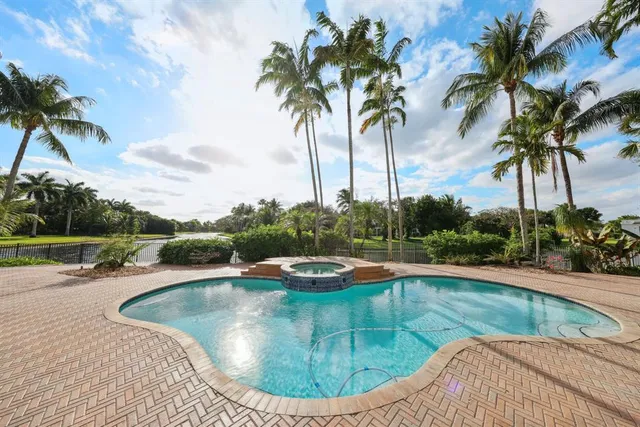 a dining hall with stainless steel appliances granite countertop a stove and a sink