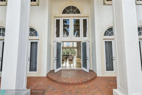 a kitchen with a dining table chairs cabinets and stainless steel appliances