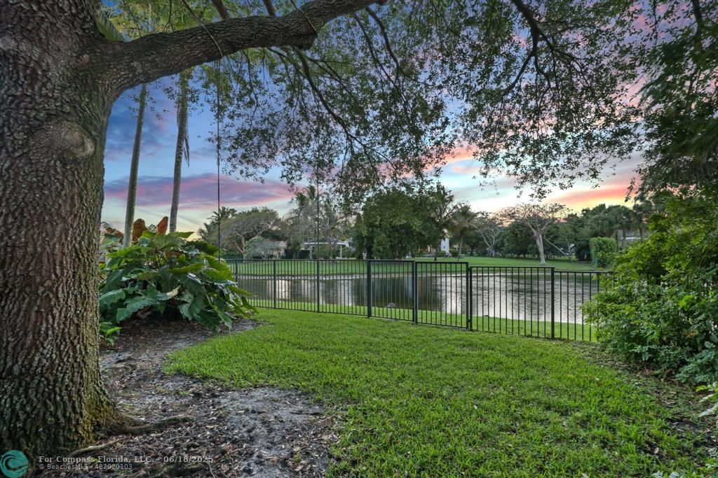 2753 West Stonebrook Circle Davie, FL 33330 - Photo 82 of 88 a backyard of a house with a lake view