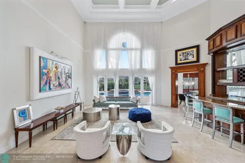 a view of a dining room with furniture and a chandelier