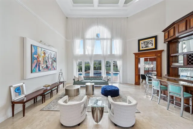a large kitchen with stainless steel appliances wooden floor and large windows