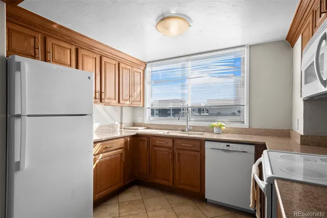 a kitchen with a sink window and cabinets