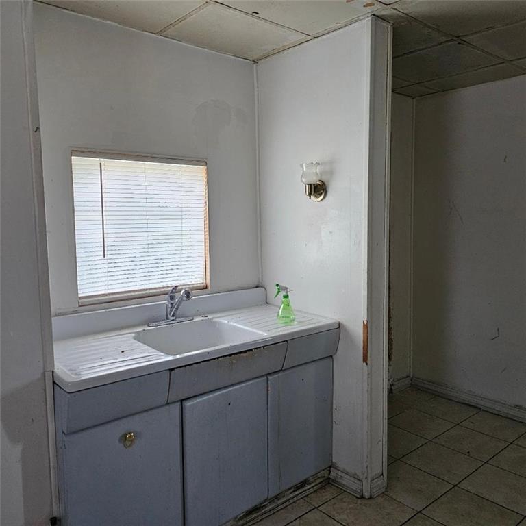 1424 4th Avenue Beaver Falls, PA 15010 - Photo 5 of 14 a bathroom with a sink and a mirror
