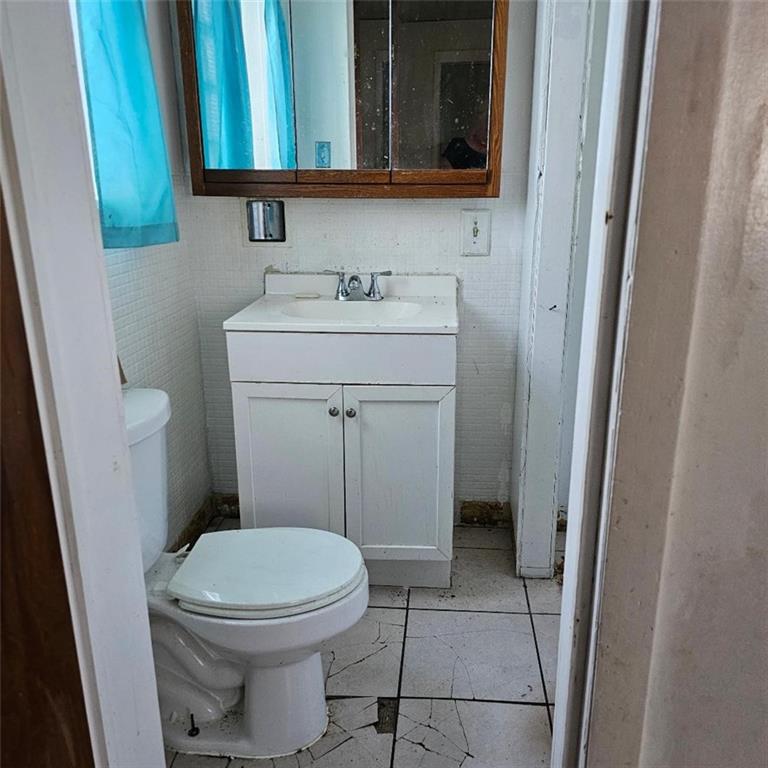 1424 4th Avenue Beaver Falls, PA 15010 - Photo 8 of 14 a bathroom with a sink and a toilet