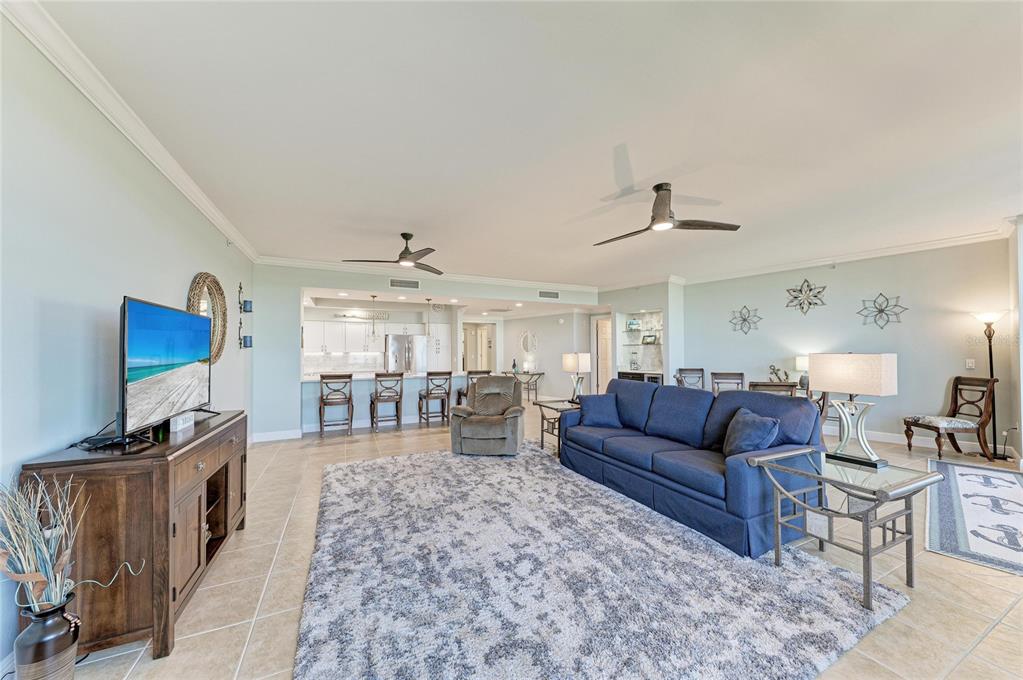3329 Sunset Key Circle, Unit 407 Punta Gorda, FL 33955 - Photo 11 of 68 a living room with furniture a flat screen tv and a fireplace