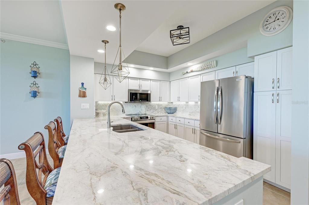 3329 Sunset Key Circle, Unit 407 Punta Gorda, FL 33955 - Photo 15 of 68 a kitchen with stainless steel appliances a refrigerator sink and microwave