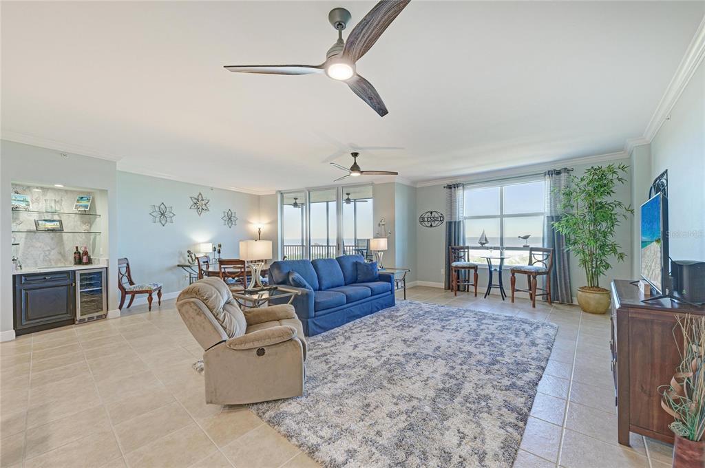 3329 Sunset Key Circle, Unit 407 Punta Gorda, FL 33955 - Photo 17 of 68 a living room with furniture a flat screen tv and a large window