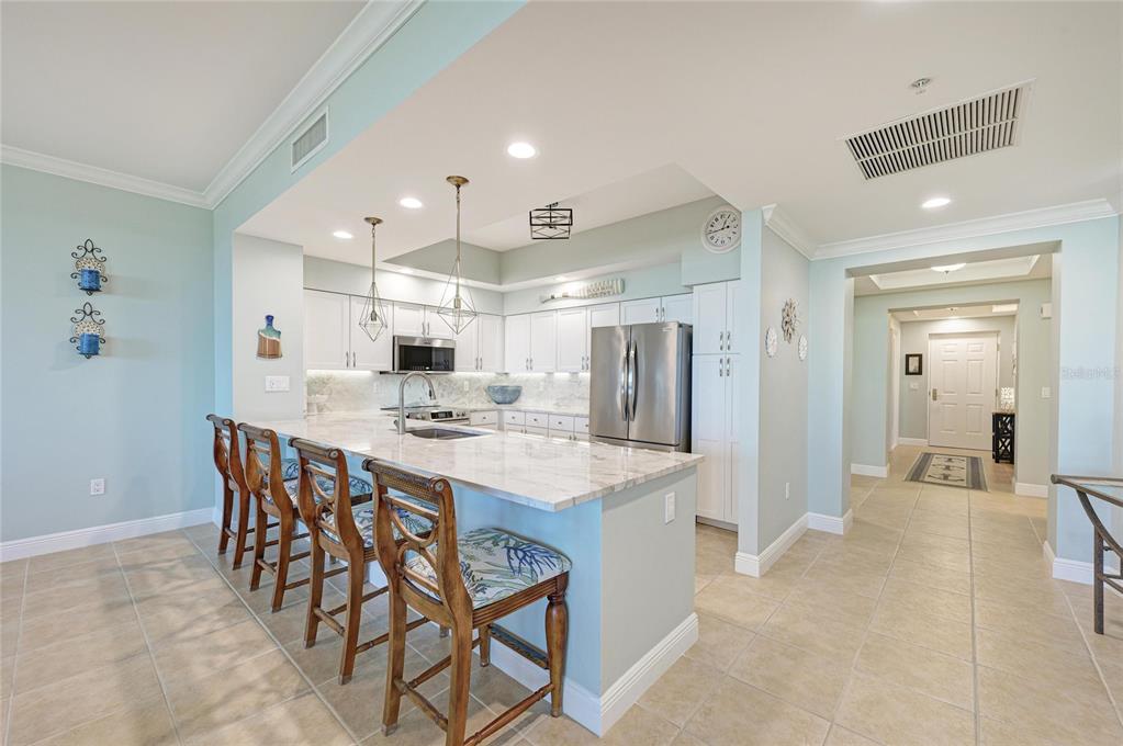 3329 Sunset Key Circle, Unit 407 Punta Gorda, FL 33955 - Photo 20 of 68 a large kitchen with a table and chairs