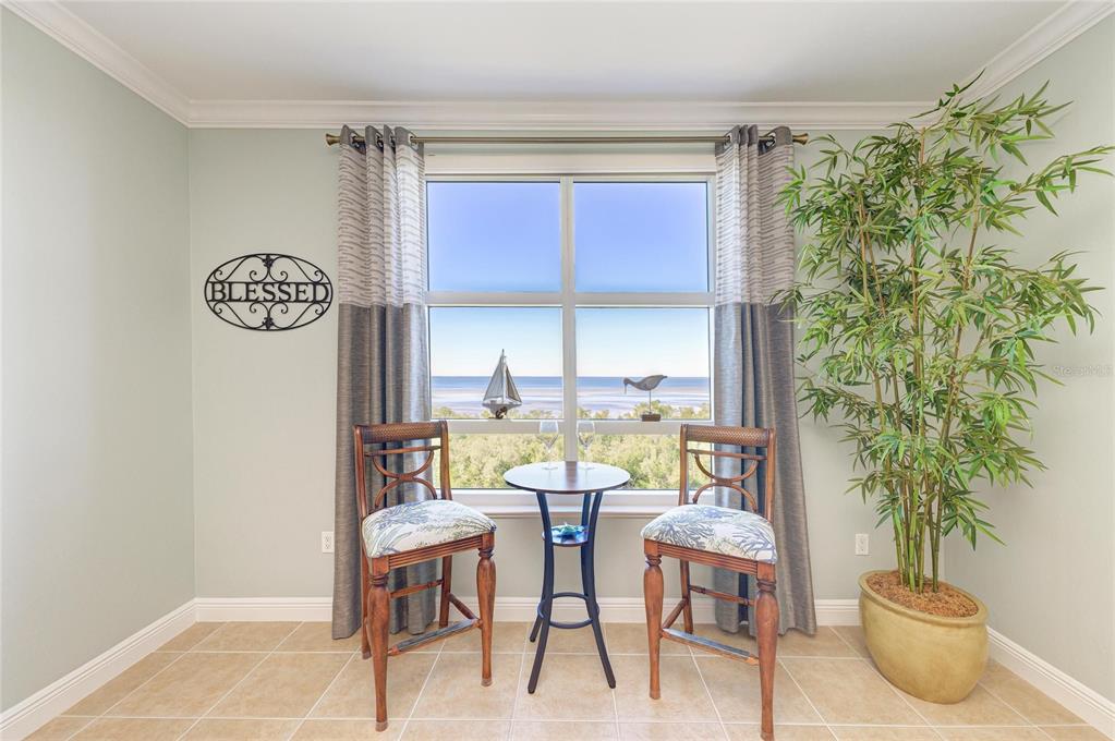 3329 Sunset Key Circle, Unit 407 Punta Gorda, FL 33955 - Photo 23 of 68 a view of a dining room with furniture and a potted plant