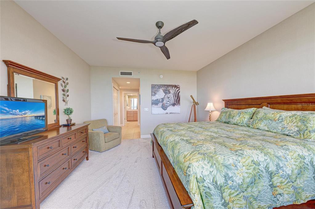 3329 Sunset Key Circle, Unit 407 Punta Gorda, FL 33955 - Photo 25 of 68 a bedroom with a large bed and a flat tv screen on dresser