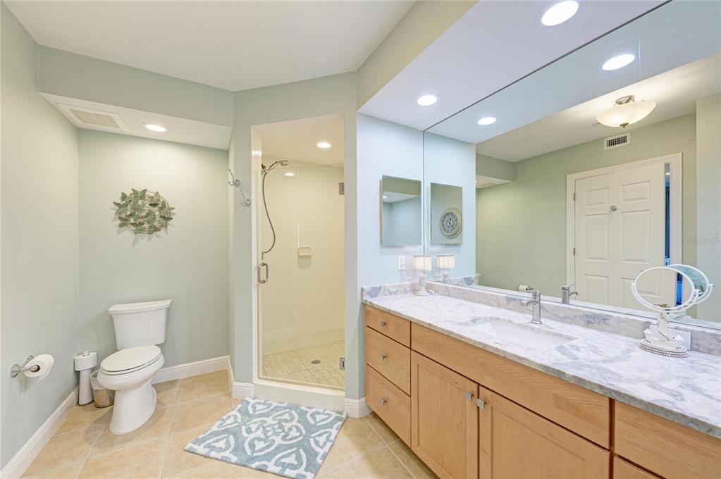 3329 Sunset Key Circle, Unit 407 Punta Gorda, FL 33955 - Photo 29 of 68 a spacious bathroom with a granite countertop sink a toilet and a shower