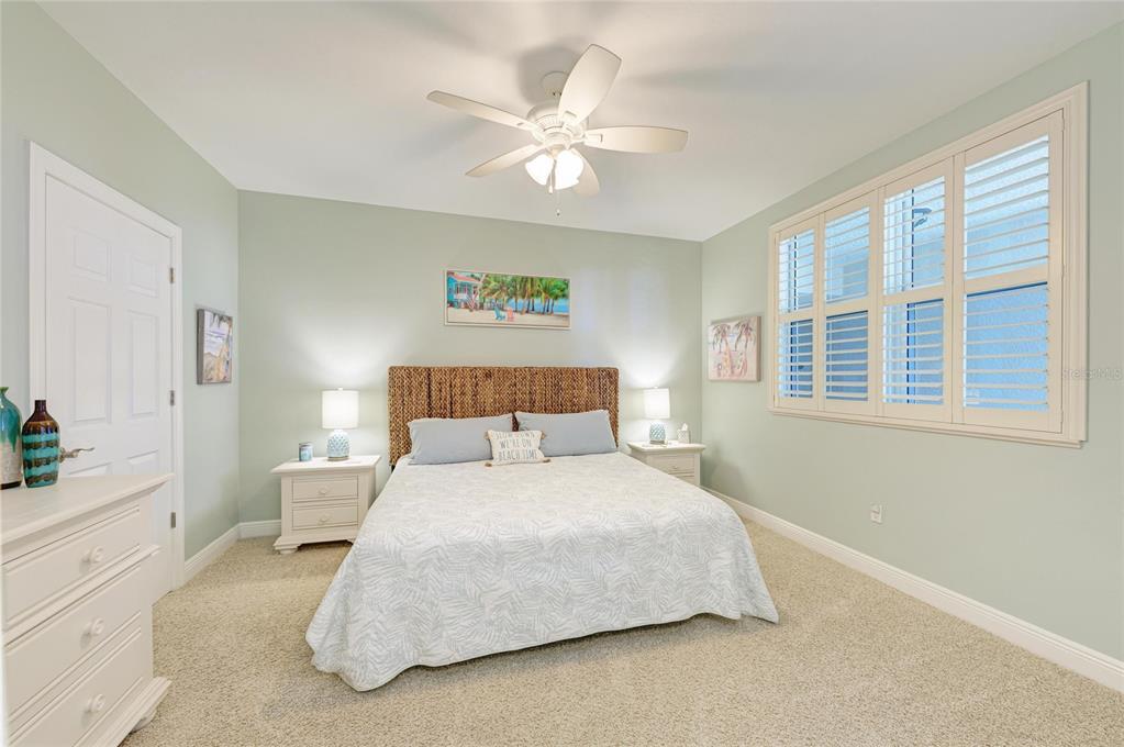3329 Sunset Key Circle, Unit 407 Punta Gorda, FL 33955 - Photo 36 of 68 a bedroom with a large bed and a chandelier