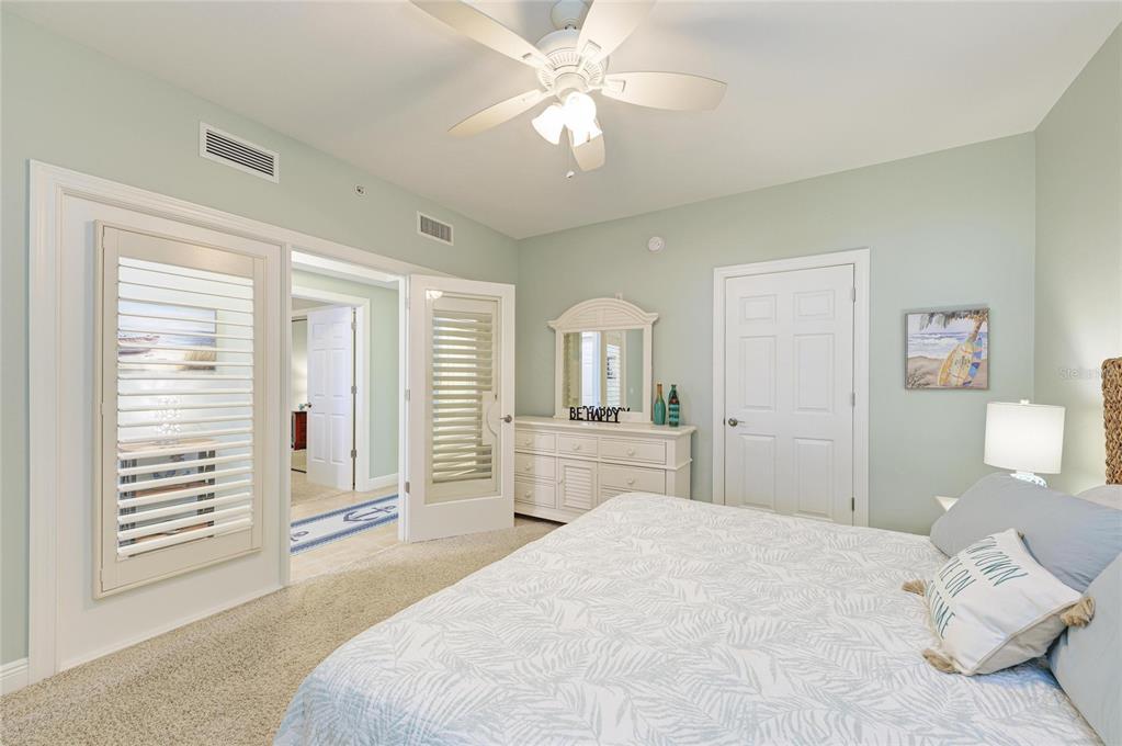 3329 Sunset Key Circle, Unit 407 Punta Gorda, FL 33955 - Photo 38 of 68 a bedroom with a large bed and a chandelier