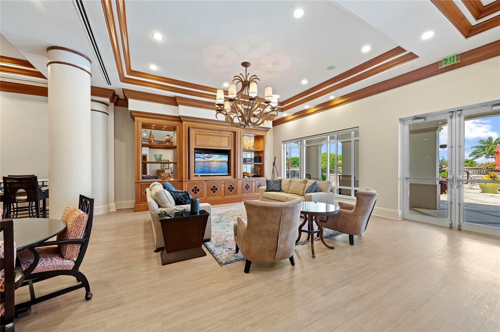 3329 Sunset Key Circle, Unit 407 Punta Gorda, FL 33955 - Photo 56 of 68 a living room with furniture a chandelier and a dining table