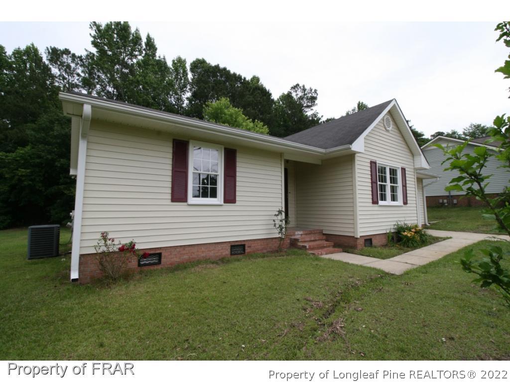 2255 Hackney Loop Fayetteville, NC 28304 - Photo 2 of 36 a backyard of a house with table and chairs