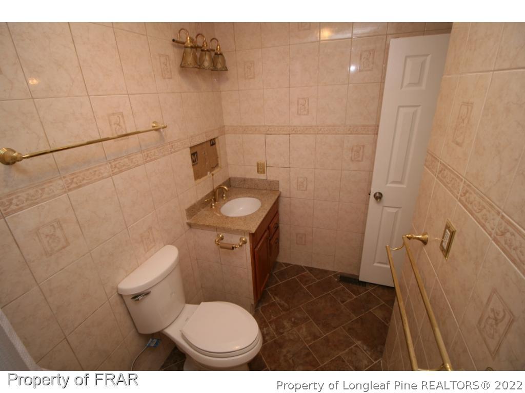 2255 Hackney Loop Fayetteville, NC 28304 - Photo 21 of 36 a bathroom with a toilet and a sink