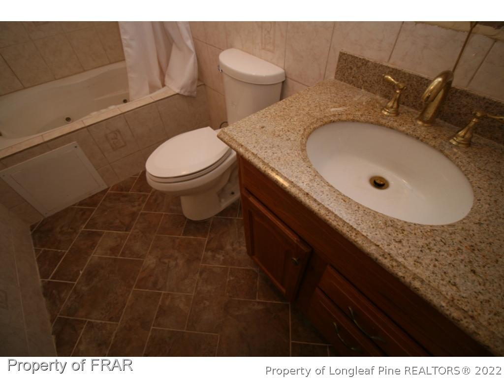 2255 Hackney Loop Fayetteville, NC 28304 - Photo 22 of 36 a bathroom with a sink and a toilet