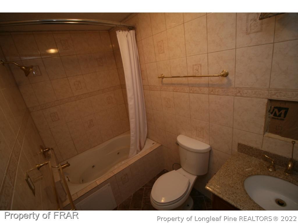 2255 Hackney Loop Fayetteville, NC 28304 - Photo 23 of 36 a bathroom with a toilet and a shower