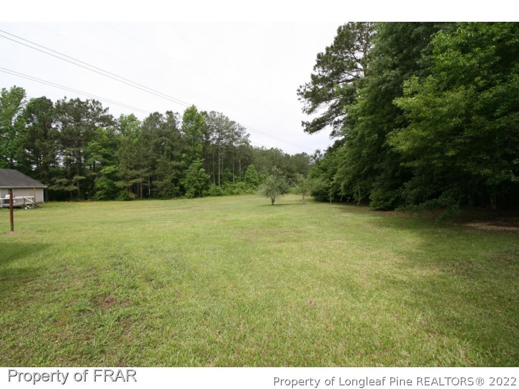 2255 Hackney Loop Fayetteville, NC 28304 - Photo 24 of 36 a view of a field with trees in the background