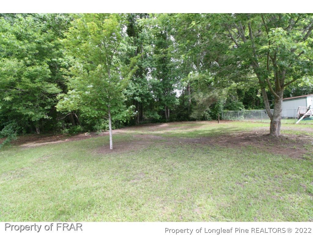 2255 Hackney Loop Fayetteville, NC 28304 - Photo 25 of 36 a backyard of a house with lots of green space