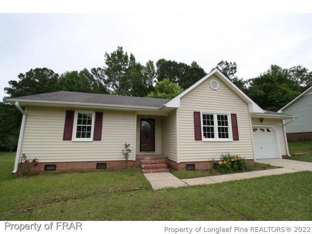 2255 Hackney Loop Fayetteville, NC 28304 - Photo 3 of 36 a front view of a house with a yard