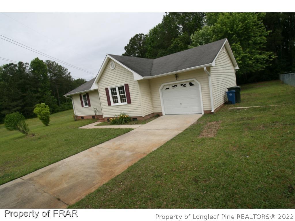 2255 Hackney Loop Fayetteville, NC 28304 - Photo 35 of 36 a front view of a house with a yard and garage