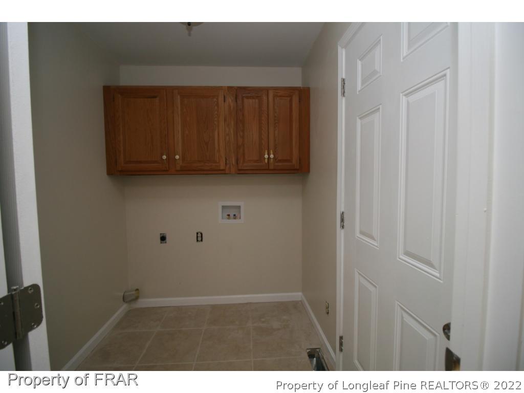 2255 Hackney Loop Fayetteville, NC 28304 - Photo 7 of 36 a view of an empty room with wooden cabinet