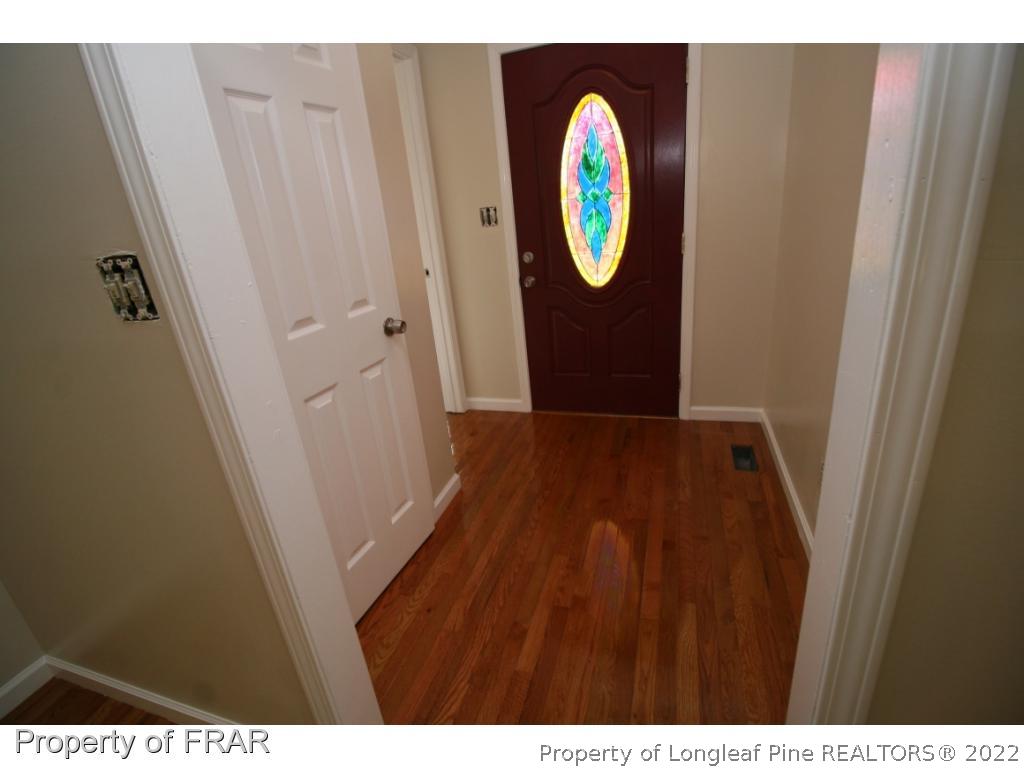 2255 Hackney Loop Fayetteville, NC 28304 - Photo 10 of 36 a view of a hallway with wooden floor