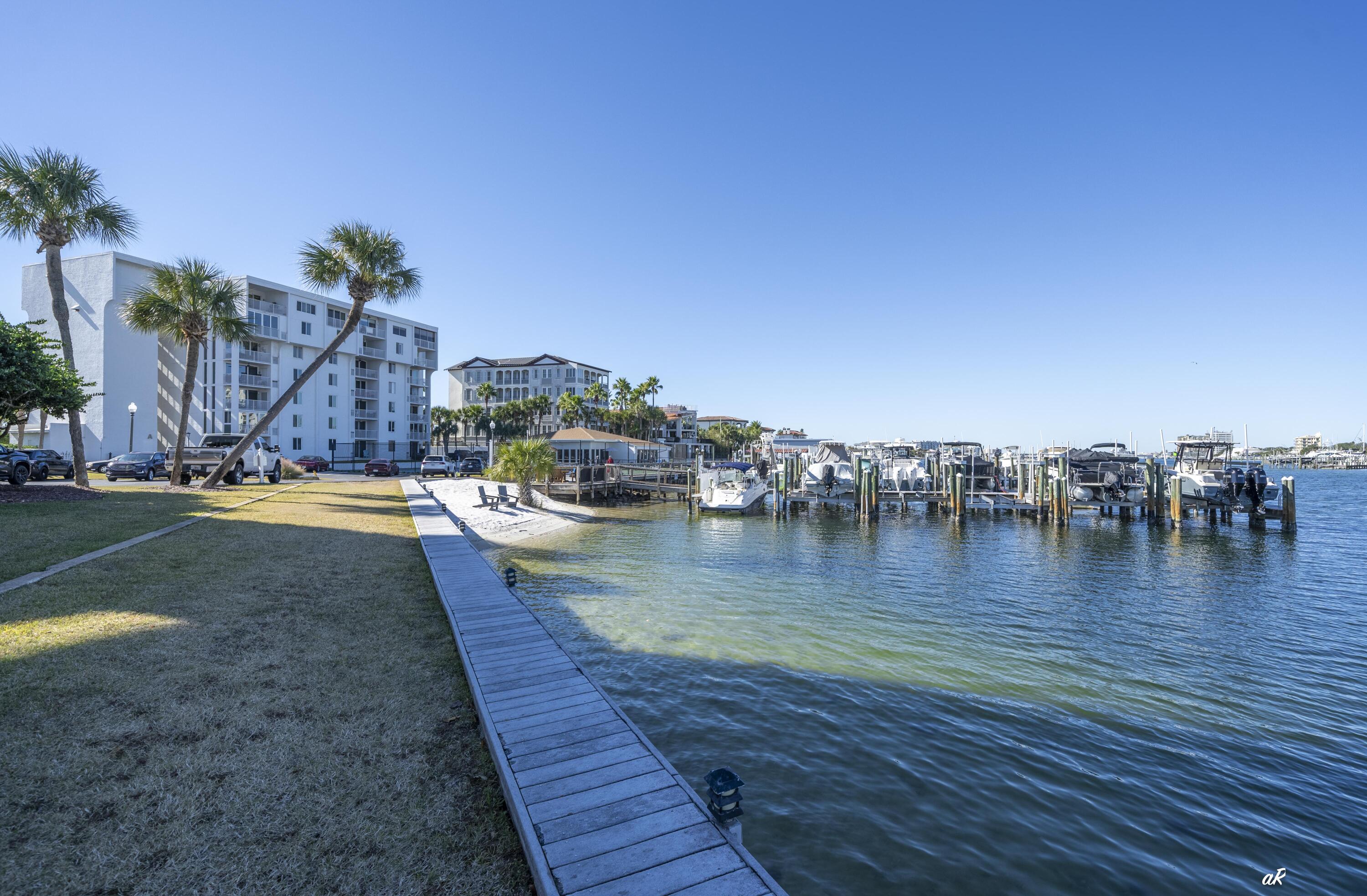 30 Moreno Point Road, Unit 404A Destin, FL 32541 - Photo 39 of 52 a view of swimming pool with outdoor seating and plants