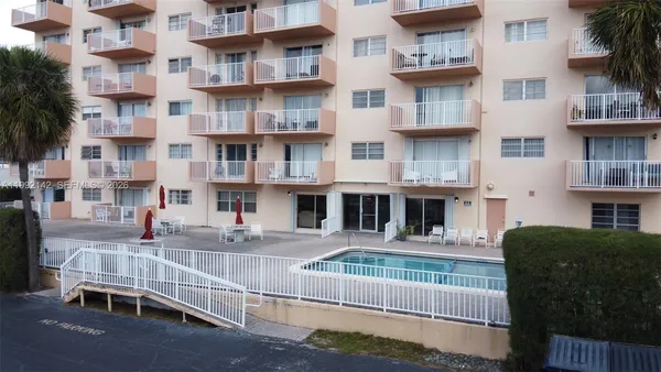 a front view of a building with glass windows and a table