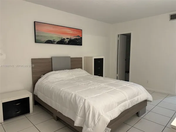 a large bed in a bedroom next to a wall