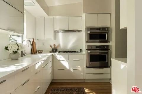 a kitchen with a sink and refrigerator