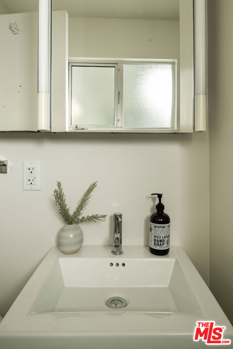 6006 Babbitt Avenue Encino, CA 91316 - Photo 19 of 32 a bathroom with a sink and a mirror